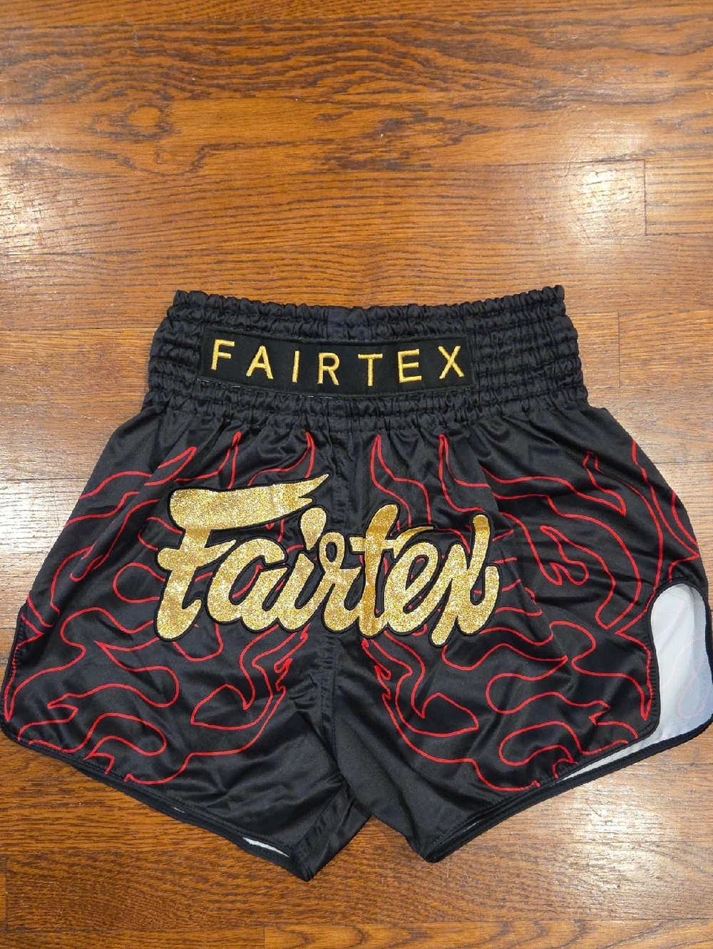 Fairtex Men's Black Athletic Shorts with Red Flame Detailing and Gold Logo